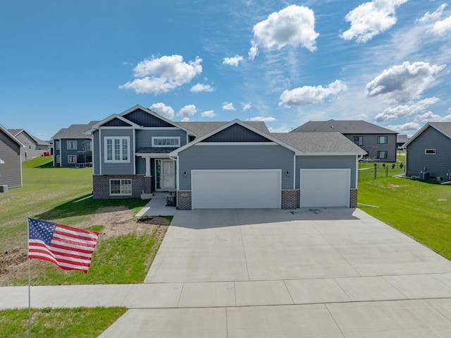 1004 7th Ave NW, Kasson, MN 55944 - view of front of home with an attached garage, brick siding, a front lawn, concrete driveway, and a residential view
