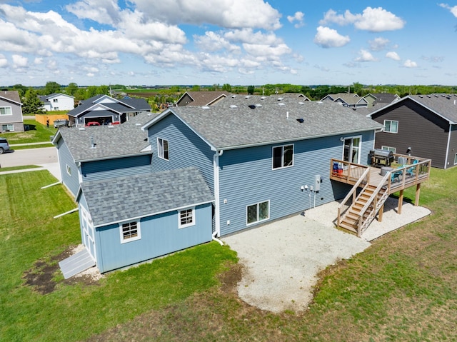 1004 7th Ave NW, Kasson, MN 55944 - back of property featuring a residential view, a shingled roof, a wooden deck, and stairs