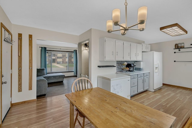 1410 12th Ave N, Saint Cloud, MN 56303 - kitchen featuring white refrigerator with ice dispenser, light wood-style floors, light countertops, and white cabinetry