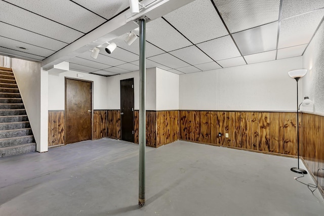 1410 12th Ave N, Saint Cloud, MN 56303 - finished basement with stairway, wood walls, a wainscoted wall, and a drop ceiling