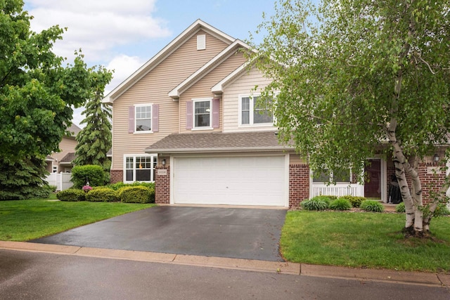 20338 Kensfield Trl Unit 1606, Lakeville, MN 55044 - traditional-style house with asphalt driveway, brick siding, a garage, and a front lawn
