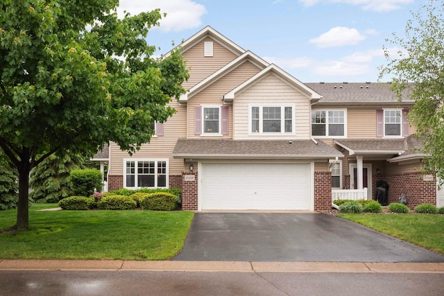 20338 Kensfield Trl Unit 1606, Lakeville, MN 55044 - view of front of house with driveway, brick siding, a garage, and a front lawn