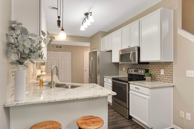 20338 Kensfield Trl Unit 1606, Lakeville, MN 55044 - kitchen featuring appliances with stainless steel finishes, tasteful backsplash, a peninsula, a sink, and white cabinets
