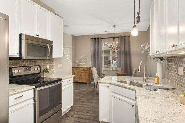 20338 Kensfield Trl Unit 1606, Lakeville, MN 55044 - kitchen featuring appliances with stainless steel finishes, a chandelier, backsplash, white cabinetry, and a sink
