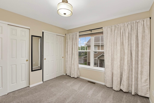 20338 Kensfield Trl Unit 1606, Lakeville, MN 55044 - unfurnished bedroom featuring baseboards, carpet, and two closets