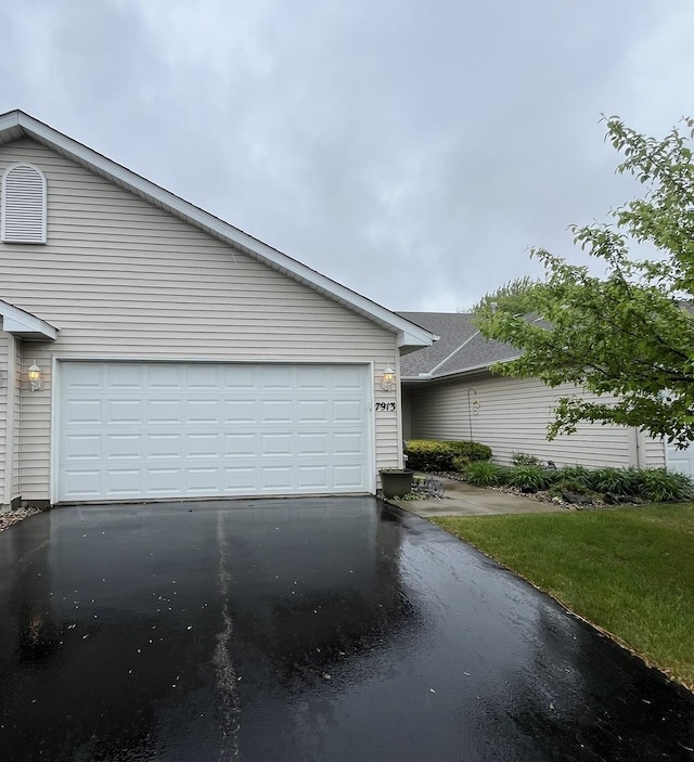 7913 Barrymore Ln, Woodbury, MN 55125 - view of front of property with driveway and an attached garage