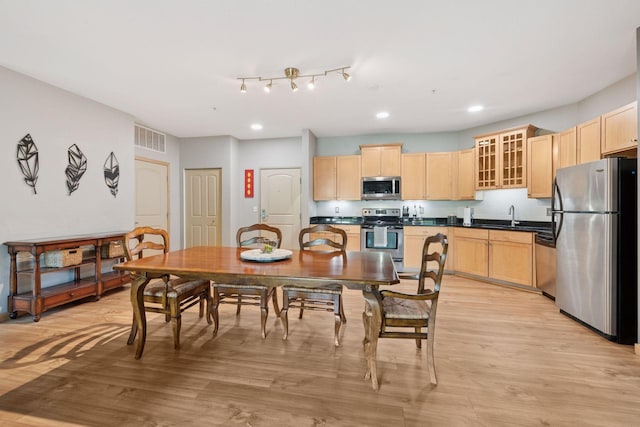 4132 Vernon Ave S Unit A103, Saint Louis Park, MN 55416 - kitchen featuring appliances with stainless steel finishes, light brown cabinets, dark countertops, light wood-type flooring, and recessed lighting
