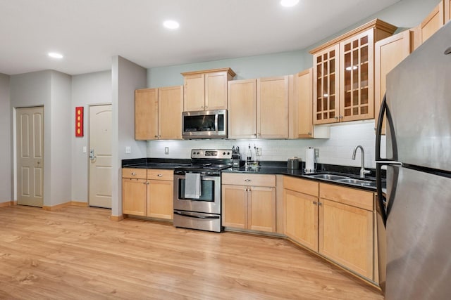 4132 Vernon Ave S Unit A103, Saint Louis Park, MN 55416 - kitchen with appliances with stainless steel finishes, a sink, light brown cabinetry, light wood-type flooring, and tasteful backsplash
