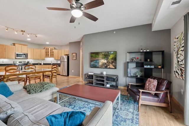 4132 Vernon Ave S Unit A103, Saint Louis Park, MN 55416 - living area featuring baseboards, light wood finished floors, and a ceiling fan