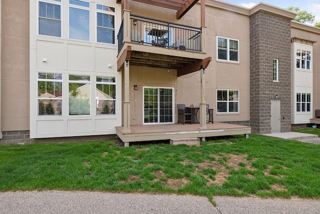 4132 Vernon Ave S Unit A103, Saint Louis Park, MN 55416 - back of house featuring a balcony, a deck, a yard, and stucco siding