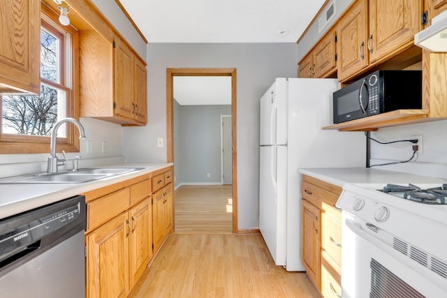 3311 Yukon Ave S, Saint Louis Park, MN 55426 - kitchen featuring stainless steel dishwasher, a sink, black microwave, white gas range, and light countertops