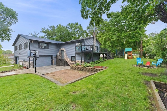 1680 Bluebird Ln, Mound, MN 55364 - back of property with stairs, concrete driveway, an attached garage, stone siding, and a playground