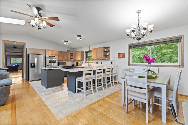1680 Bluebird Ln, Mound, MN 55364 - dining space with light wood-style floors, vaulted ceiling, a chandelier, plenty of natural light, and ceiling fan