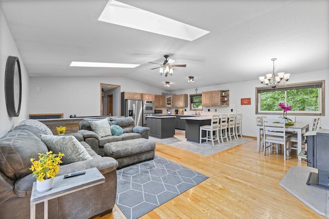 1680 Bluebird Ln, Mound, MN 55364 - living area with a skylight, light wood finished floors, a chandelier, lofted ceiling, and a ceiling fan