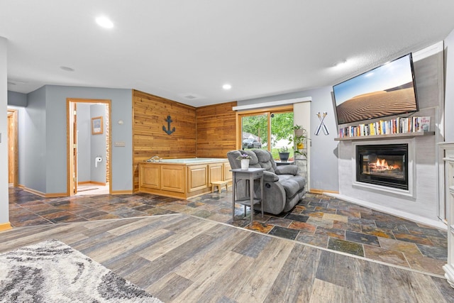 1680 Bluebird Ln, Mound, MN 55364 - living area with a glass covered fireplace, baseboards, stone finish flooring, and recessed lighting