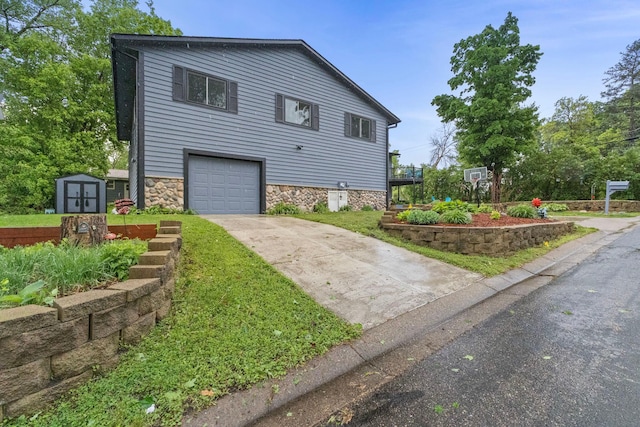 1680 Bluebird Ln, Mound, MN 55364 - view of front of house with concrete driveway, stone siding, and an attached garage