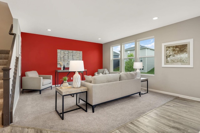 5010 Sandpebble Ln, Woodbury, MN 55129 - living area with wood finished floors, an accent wall, stairs, baseboards, and recessed lighting