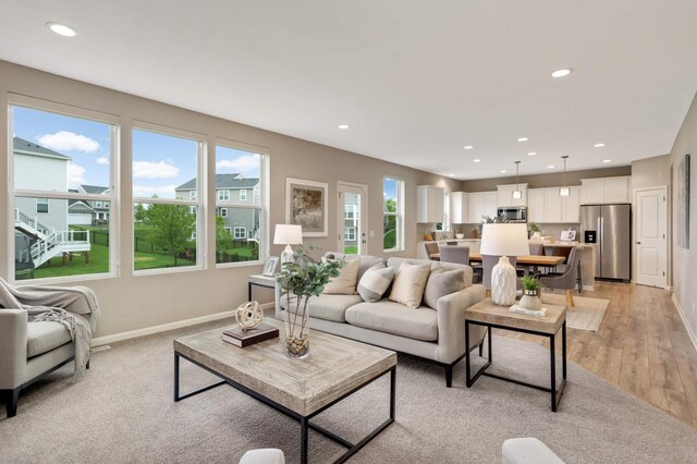 5010 Sandpebble Ln, Woodbury, MN 55129 - living area with recessed lighting, light wood-type flooring, and baseboards