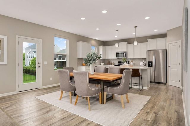 5010 Sandpebble Ln, Woodbury, MN 55129 - dining area with light wood-style flooring, recessed lighting, and baseboards