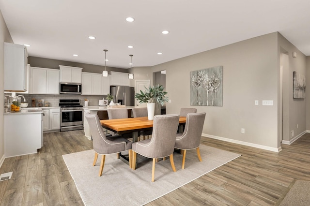 5010 Sandpebble Ln, Woodbury, MN 55129 - dining space with recessed lighting, light wood-style flooring, and baseboards