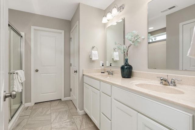 5010 Sandpebble Ln, Woodbury, MN 55129 - full bathroom with double vanity, a stall shower, and baseboards