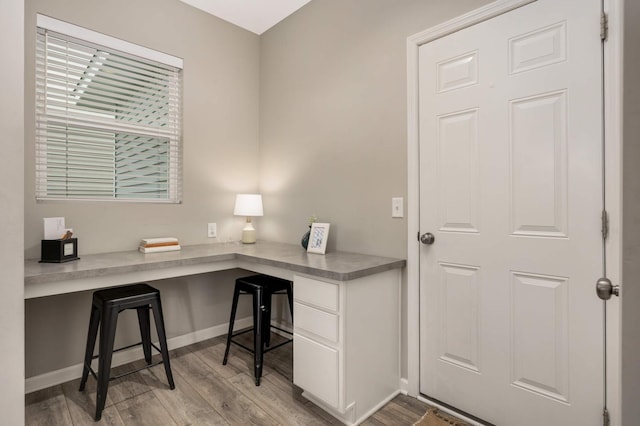 5010 Sandpebble Ln, Woodbury, MN 55129 - office area with built in study area, light wood-style flooring, and baseboards