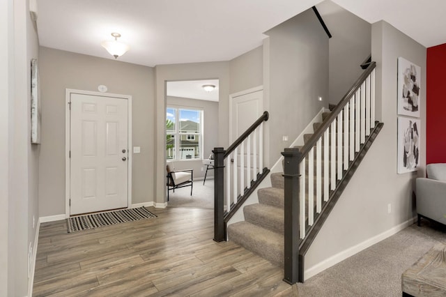 5010 Sandpebble Ln, Woodbury, MN 55129 - entryway featuring wood finished floors, baseboards, and stairway