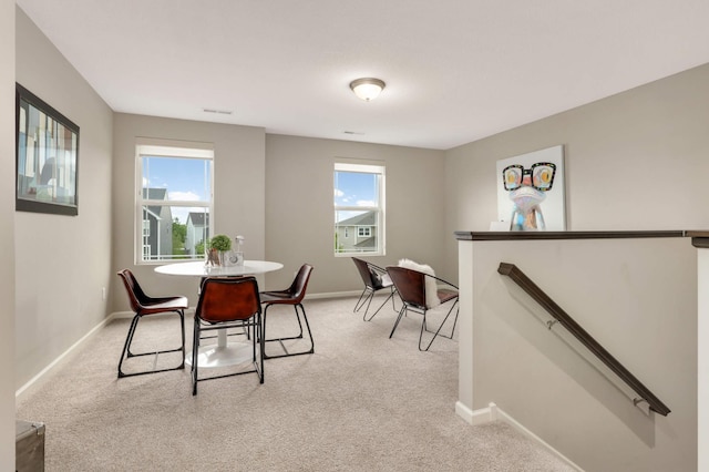 5010 Sandpebble Ln, Woodbury, MN 55129 - dining space featuring light carpet, plenty of natural light, and baseboards