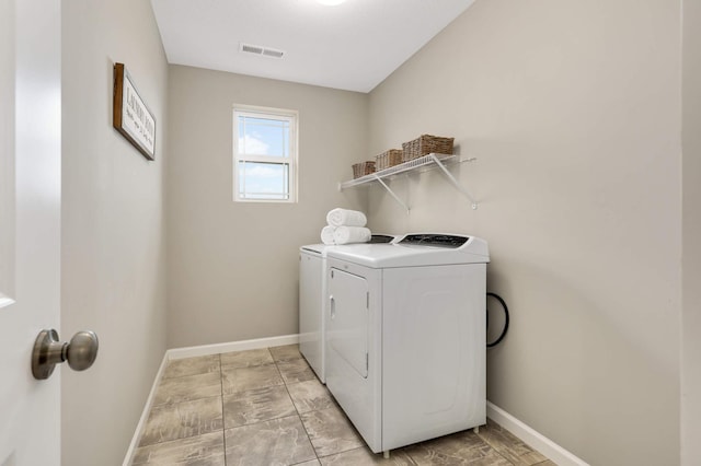 5010 Sandpebble Ln, Woodbury, MN 55129 - laundry room with separate washer and dryer and baseboards