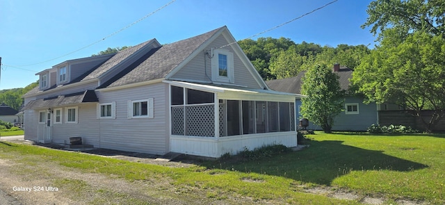 520 New St, Whalan, MN 55949 - view of side of property with a sunroom, a yard, and a shingled roof