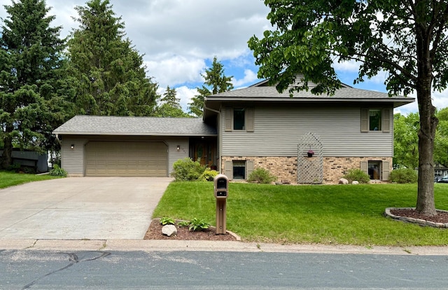 507 Pine Ridge Ter, River Falls, WI 54022 - tri-level home featuring an attached garage, a front yard, and driveway