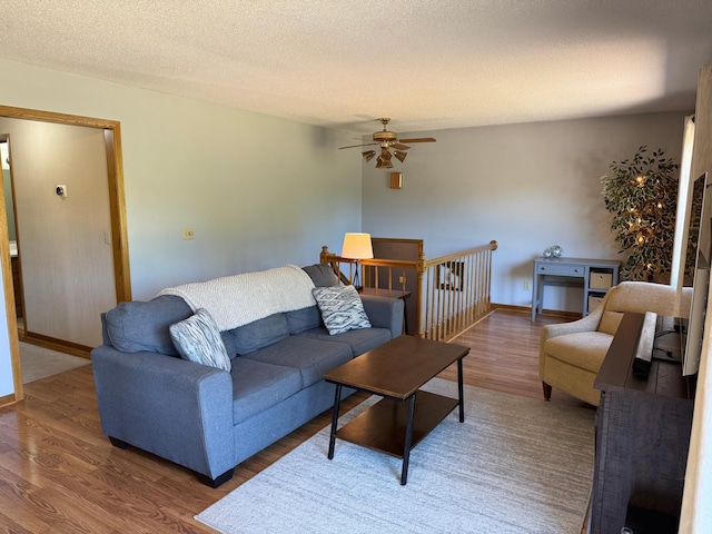 507 Pine Ridge Ter, River Falls, WI 54022 - living room featuring wood finished floors, ceiling fan, and a textured ceiling