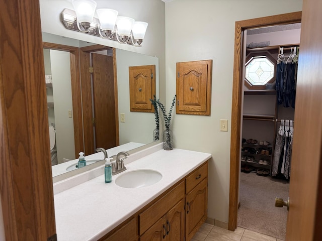 507 Pine Ridge Ter, River Falls, WI 54022 - bathroom with vanity, tile patterned flooring, and a walk in closet