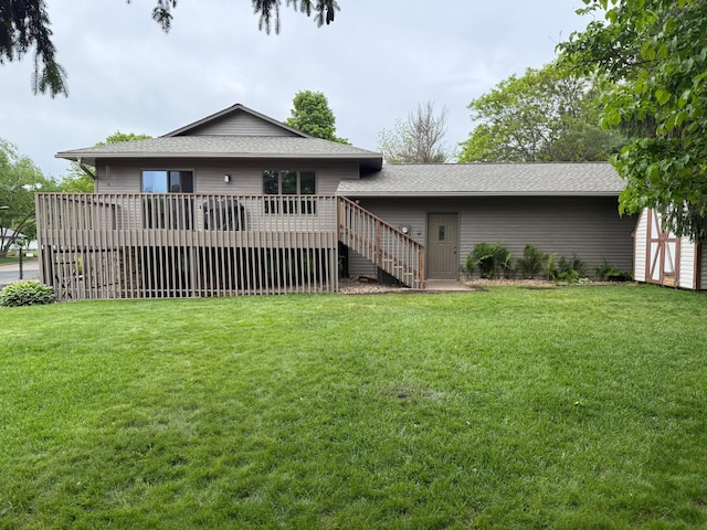 507 Pine Ridge Ter, River Falls, WI 54022 - back of property with a deck, a lawn, and roof with shingles