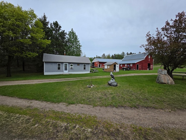 11005 320th St, Clover Twp, MN 56470 - view of front of home with a front yard, an outdoor structure, and a barn