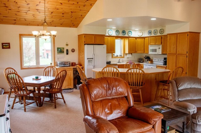 11005 320th St, Clover Twp, MN 56470 - kitchen featuring white appliances, a chandelier, light countertops, light colored carpet, and high vaulted ceiling