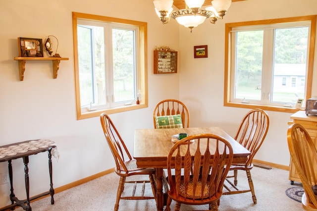11005 320th St, Clover Twp, MN 56470 - dining area with light carpet, plenty of natural light, a chandelier, and baseboards
