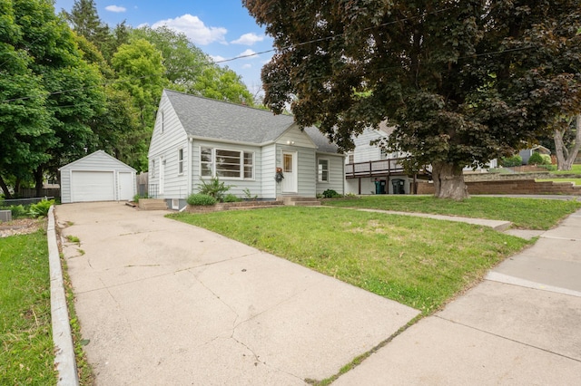 1507 7th Ave NW, Rochester, MN 55901 - view of front of property featuring an outbuilding, roof with shingles, a detached garage, and a front yard