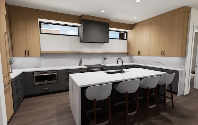 2815 44th St Unit 15, Minneapolis, MN 55410 - kitchen featuring stainless steel oven, a sink, backsplash, light stone countertops, and a breakfast bar