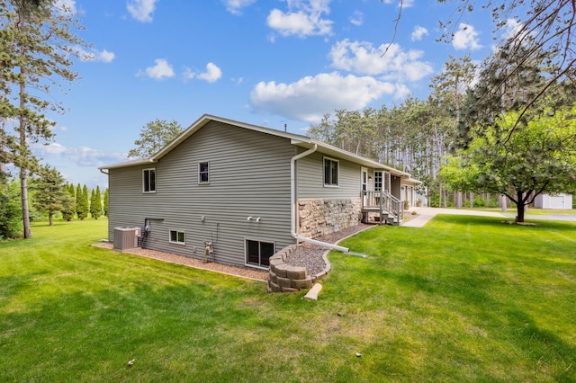 4765 344th Ln NW, Cambridge, MN 55008 - view of home's exterior featuring cooling unit, a lawn, and stone siding