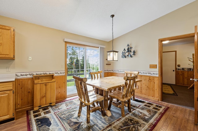 4765 344th Ln NW, Cambridge, MN 55008 - dining area featuring a wainscoted wall, hardwood / wood-style flooring, wooden walls, and vaulted ceiling