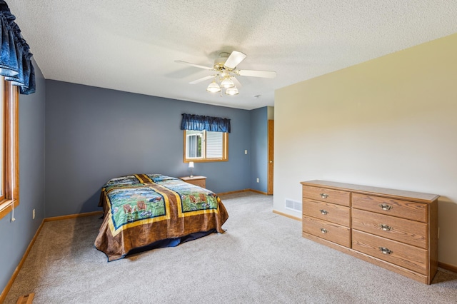 4765 344th Ln NW, Cambridge, MN 55008 - bedroom featuring light carpet, a textured ceiling, a ceiling fan, and baseboards