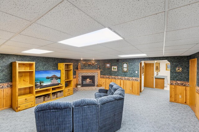 4765 344th Ln NW, Cambridge, MN 55008 - living room with wainscoting, wooden walls, light carpet, a paneled ceiling, and a fireplace