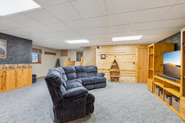4765 344th Ln NW, Cambridge, MN 55008 - carpeted living area featuring wood walls, stairs, and a paneled ceiling