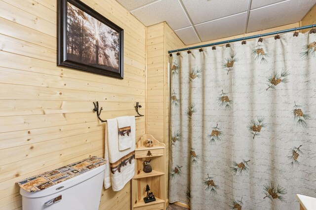 4765 344th Ln NW, Cambridge, MN 55008 - bathroom with a paneled ceiling, toilet, wooden walls, and a shower with shower curtain