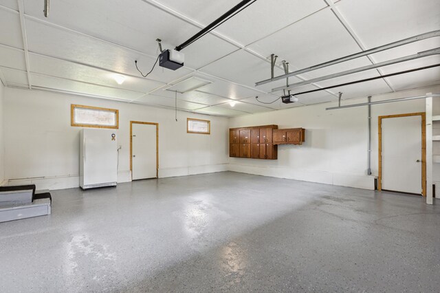 4765 344th Ln NW, Cambridge, MN 55008 - garage with a garage door opener and freestanding refrigerator
