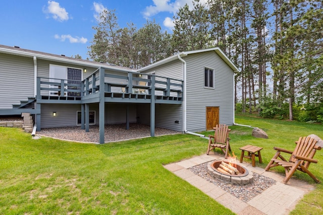 4765 344th Ln NW, Cambridge, MN 55008 - back of property featuring a fire pit, a wooden deck, and a lawn