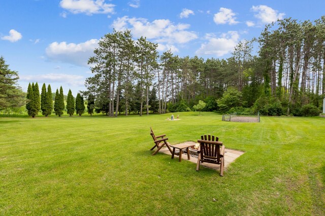 4765 344th Ln NW, Cambridge, MN 55008 - view of green lawn featuring an outdoor fire pit and view of wooded area