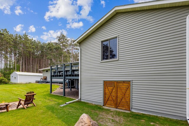 4765 344th Ln NW, Cambridge, MN 55008 - back of house with a yard, a wooden deck, an outdoor structure, and a fire pit