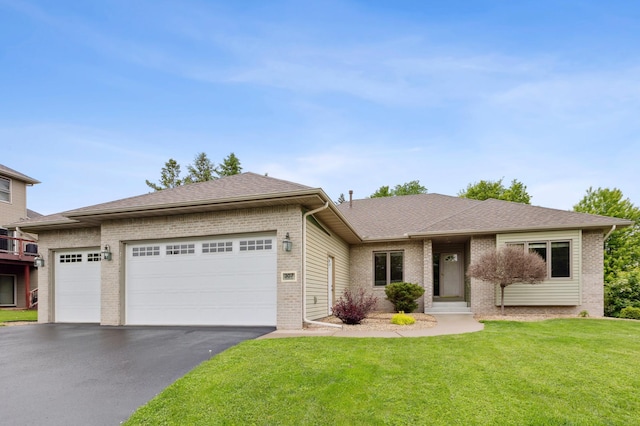 307 Lincoln Dr SE, Saint Michael, MN 55376 - view of front of home featuring brick siding, asphalt driveway, an attached garage, a front yard, and roof with shingles